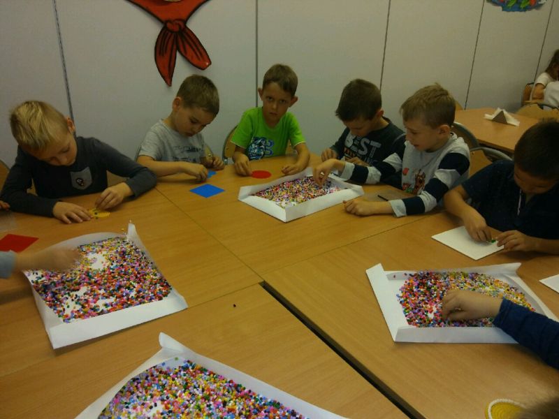 Dzieci układają koraliki.